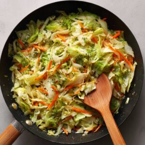 A close-up image showing the cooked egg roll bowl mixture, featuring vegetables and ground meat.