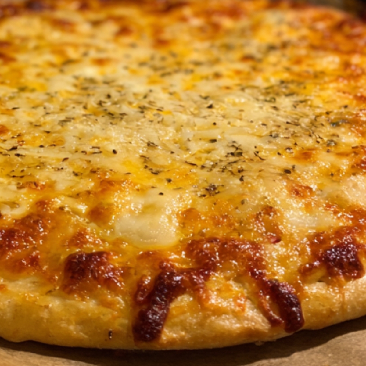 A close-up of a golden-baked cheese pizza with a slightly crispy crust.