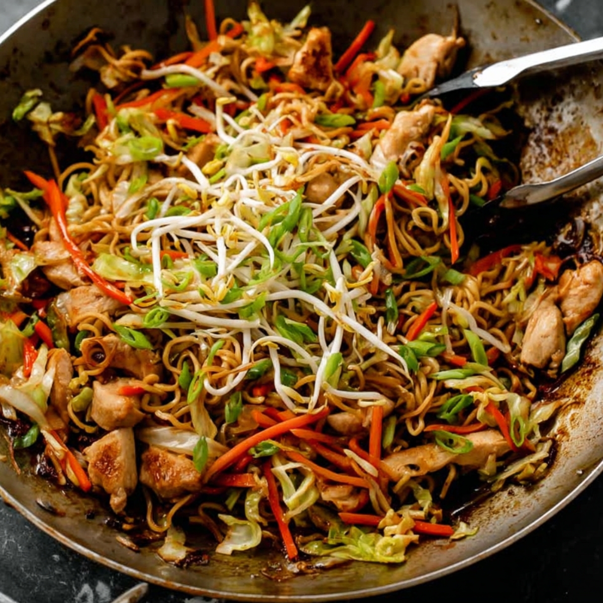 A sizzling wok filled with a delicious stir-fry, featuring tender chicken, vibrant vegetables, and noodles, all coated with a savory sauce. It's a perfectly balanced meal, full of flavor and texture, topped with fresh bean sprouts.