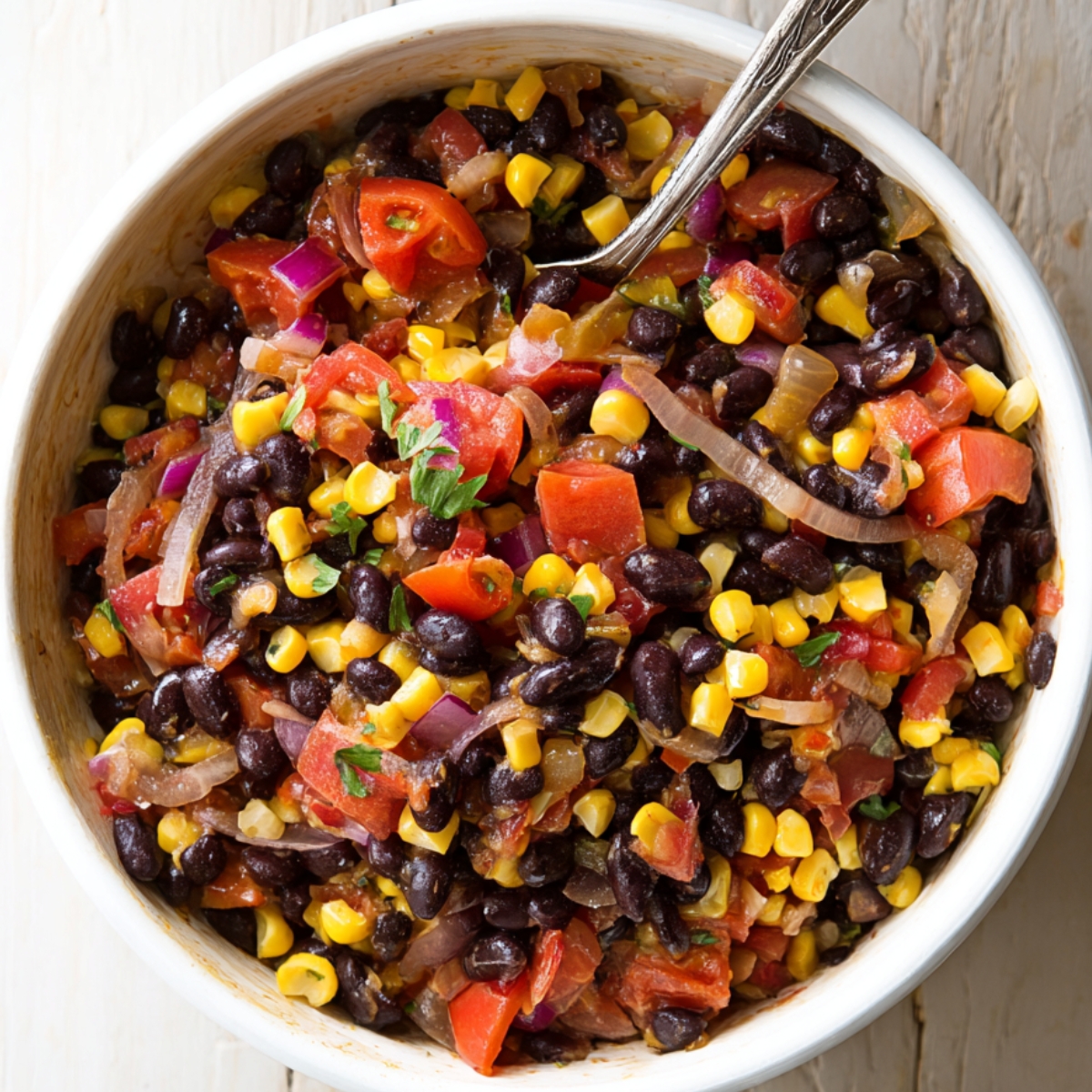A hearty mix of black beans, corn, and tomatoes simmering together, creating a flavorful base for countless dishes like tacos, bowls, or even a side for grilled meats.