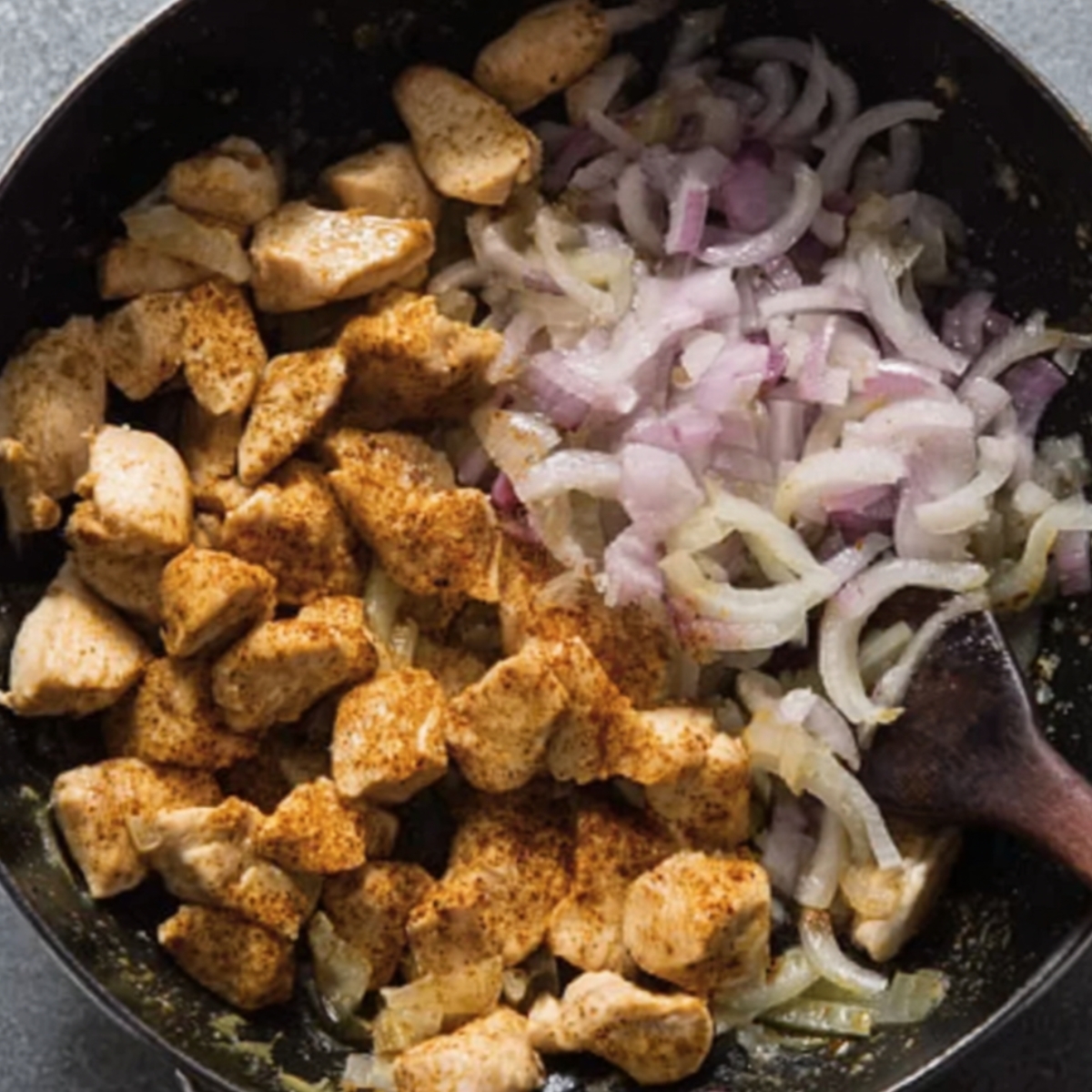 Start by sautéing onions and chicken in a pan, creating the perfect base for a flavorful Thai red curry. The combination of sautéed onions and seasoned chicken sets the stage for the rich, spicy curry that follows.