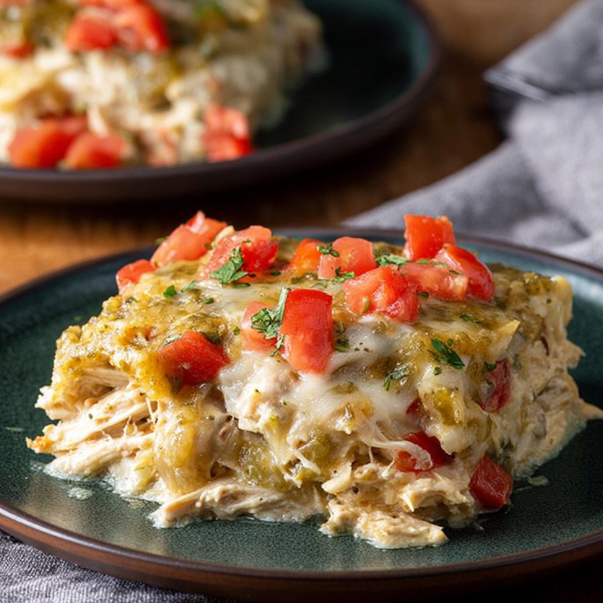 Salsa Verde Chicken Casserole Salsa Verde Chicken Casserole: This image showcases a delicious serving of Salsa Verde Chicken Casserole topped with fresh diced tomatoes and a sprinkle of herbs, offering a warm, comforting dish with tender shredded chicken and melted cheese.