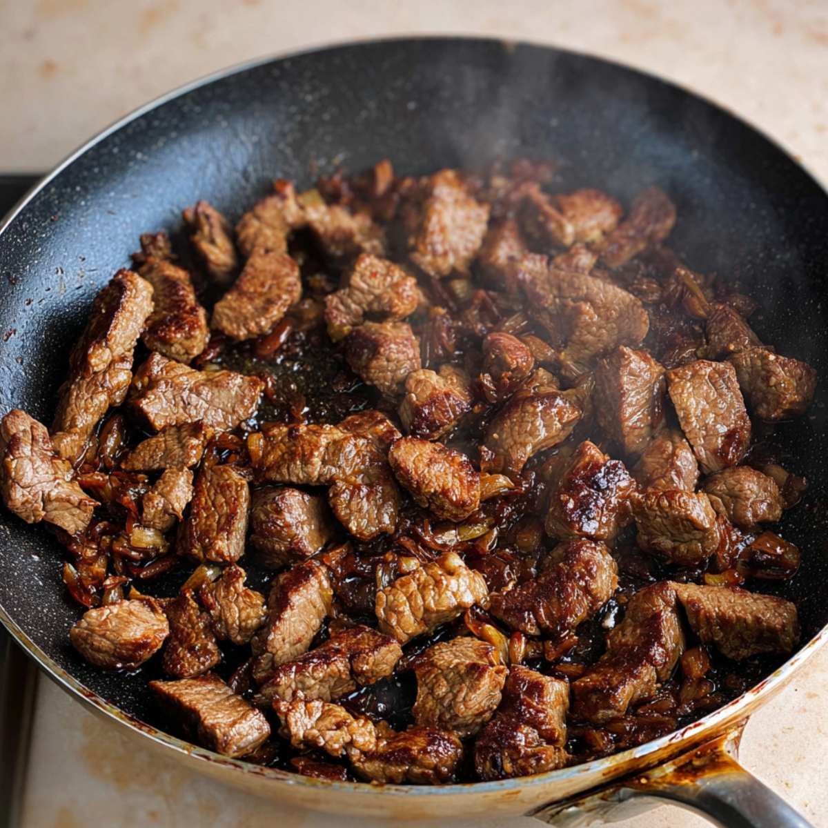 Golden caramelized onions in a pan, adding rich, sweet flavor to the savory filling of a Greek meat pie.