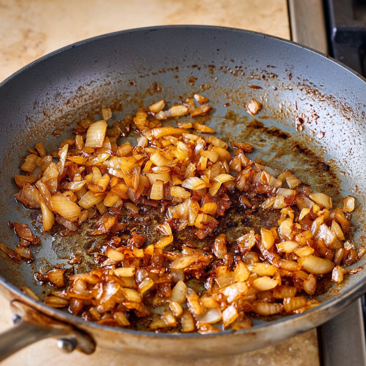 Golden caramelized onions in a pan, adding rich, sweet flavor to the savory filling of a Greek meat pie.