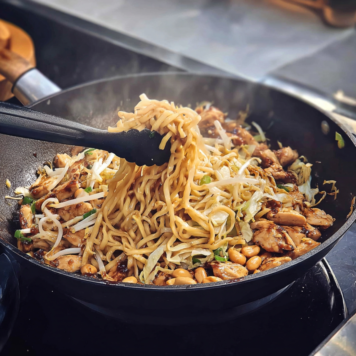A wok full of sizzling Kung Pao Chicken being tossed with noodles, bean sprouts, cabbage, and peanuts. The dish is being carefully mixed, allowing the sauce to coat each noodle and vegetable piece, creating a hearty and flavorful meal.
