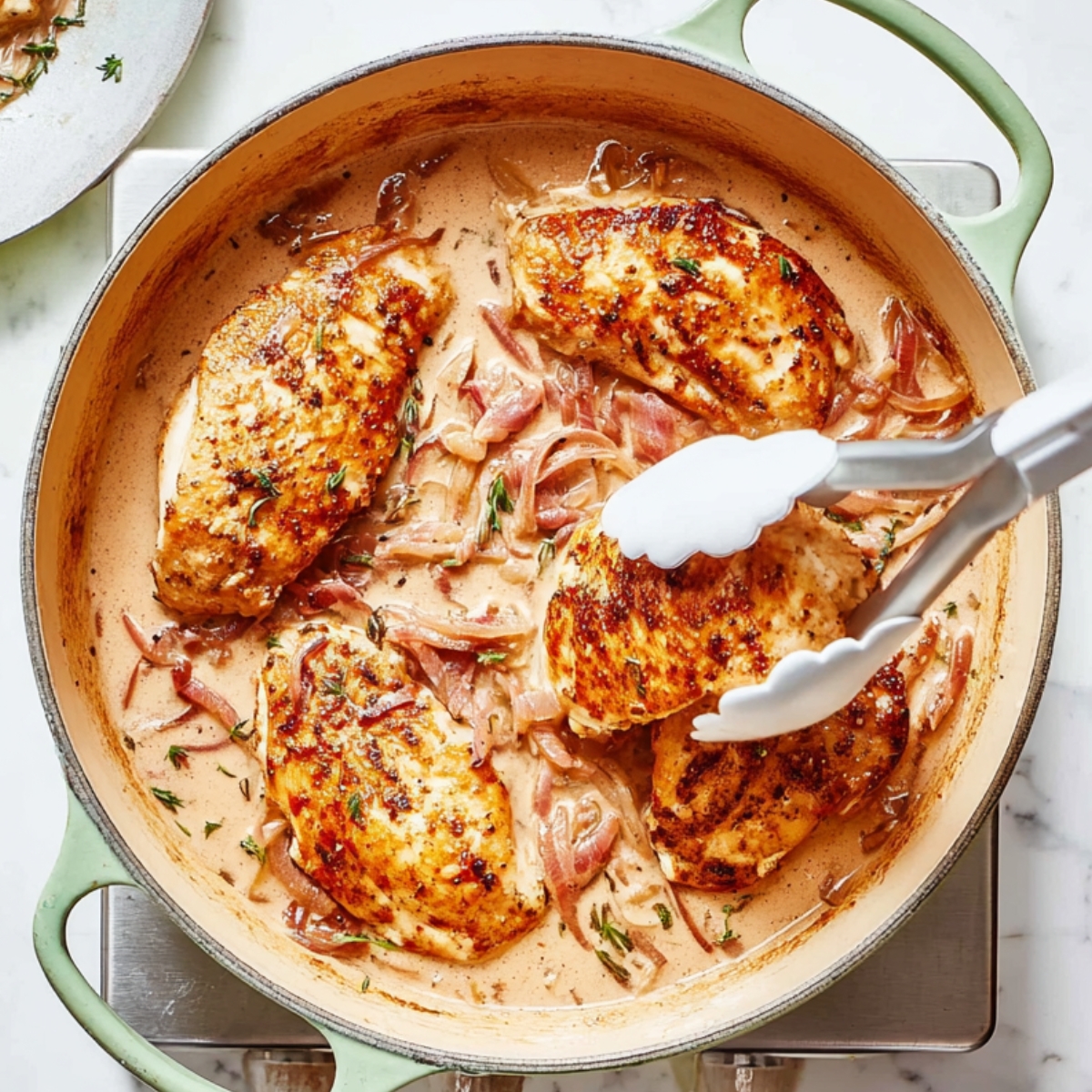 Golden seared chicken simmering in a creamy tomato sauce rich, tender, and irresistible.