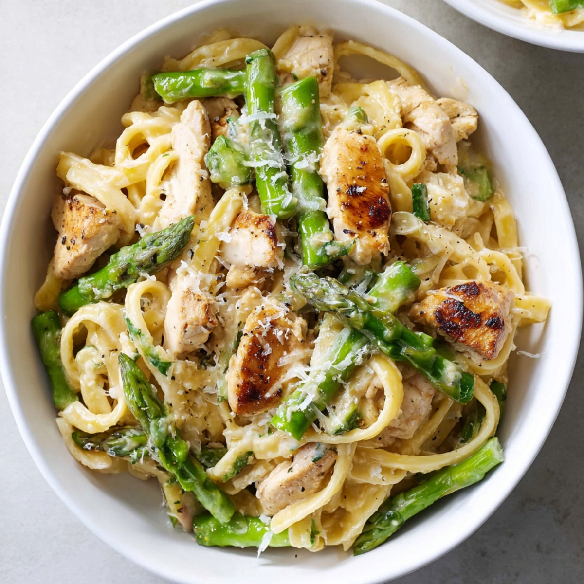 Chicken Asparagus Pasta Savor the perfect harmony of flavors in this creamy pasta with golden grilled chicken pieces and fresh green asparagus. Finished with a sprinkle of Parmesan cheese, this dish is a feast for the eyes and the taste buds. Easy to make, packed with nutrients, and irresistibly creamy, it’s a simple yet elegant recipe that will elevate any weeknight dinner or special occasion meal!