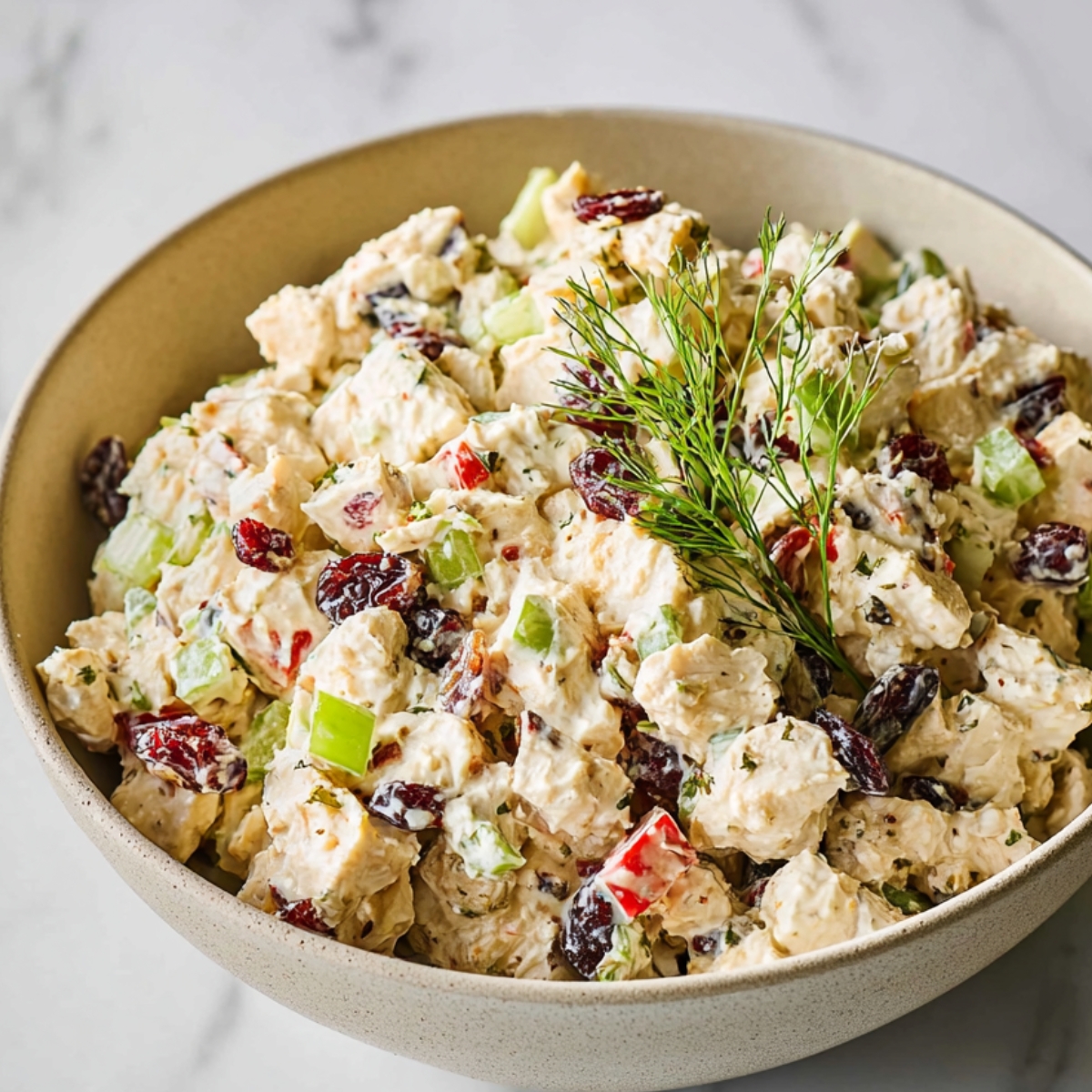 Chicken Salad with Fresh Apples
Close up of a creamy chicken salad in a beige bowl, filled with diced chicken, celery, red bell peppers, dried cranberries, and herbs, lightly coated in a rich dressing, garnished with fresh green sprigs, soft natural lighting, marble countertop background, high detail, food photography, shallow depth of field, realistic texture, appetizing presentation