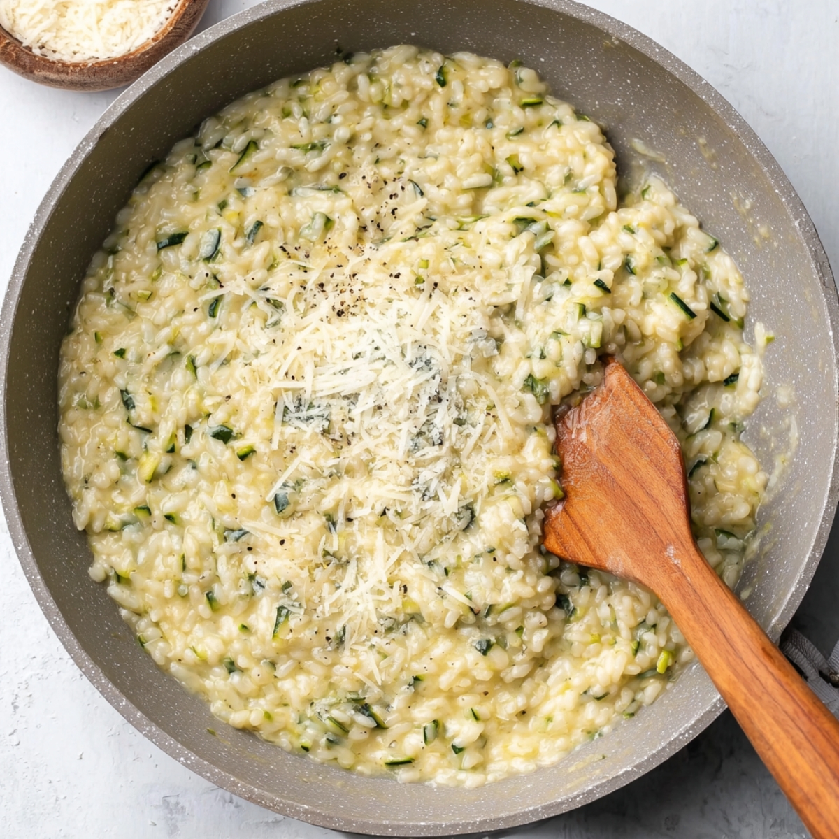 creamy risotto in skillet with cheese on top Cheesy Zucchini Risotto