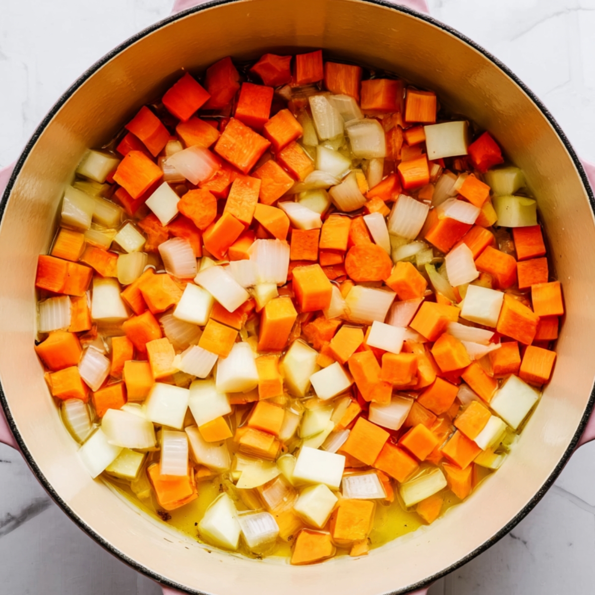 Close up of a pink enameled pot filled with chopped ripe tomatoes, fresh herbs, and a sprinkle of salt in a savory broth, top-down view, bright natural lighting, clean hexagonal tile kitchen countertop, vibrant food preparation photography style